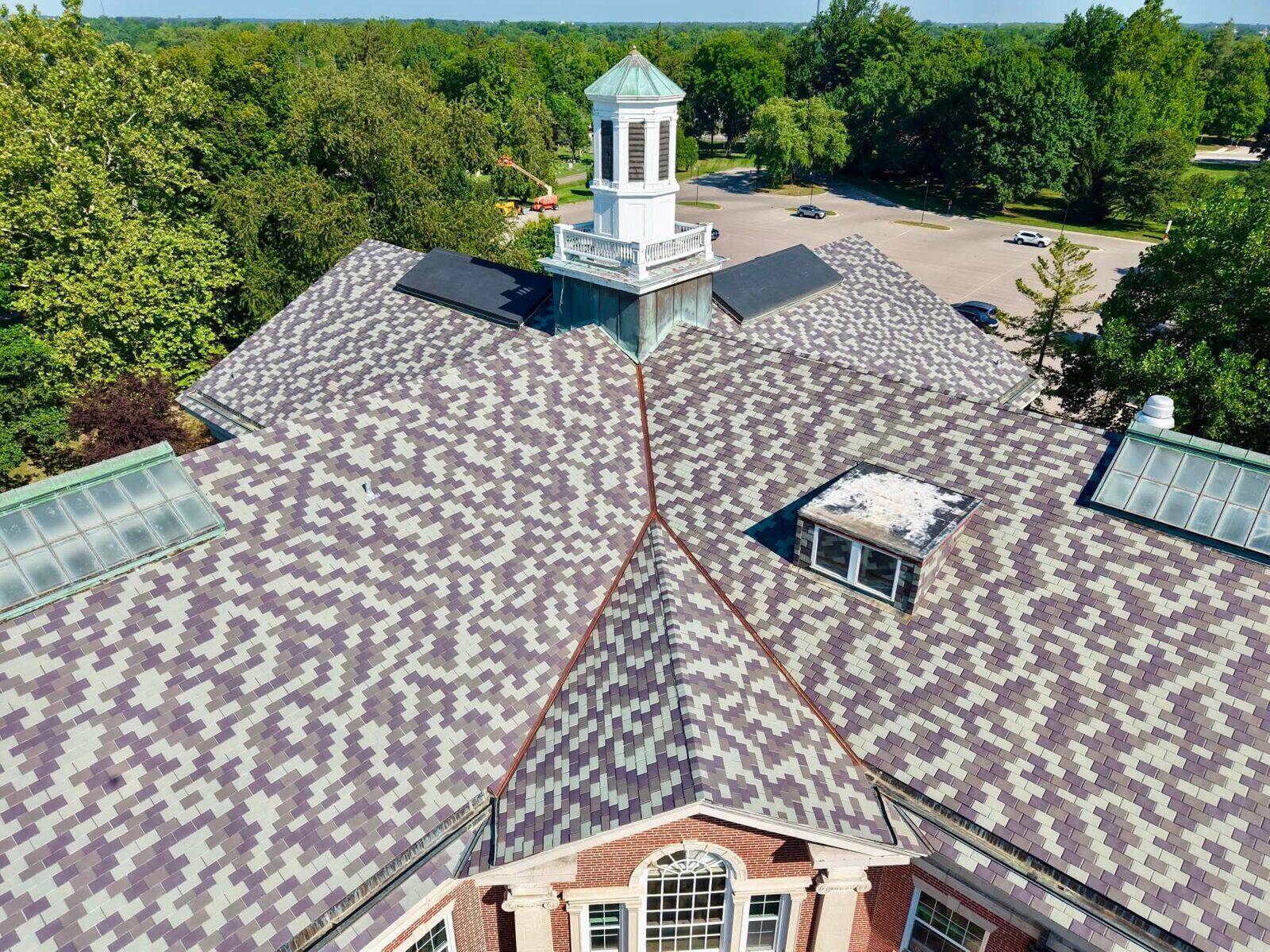 Detail view of a civic building's cupola and newly installed shingle roofing.