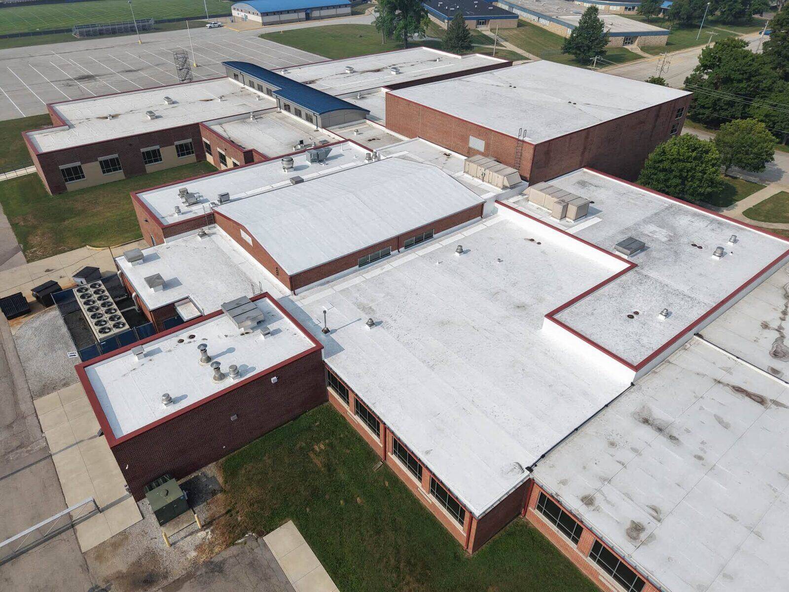 Brick institutional buildings with low-slope commercial roofing.