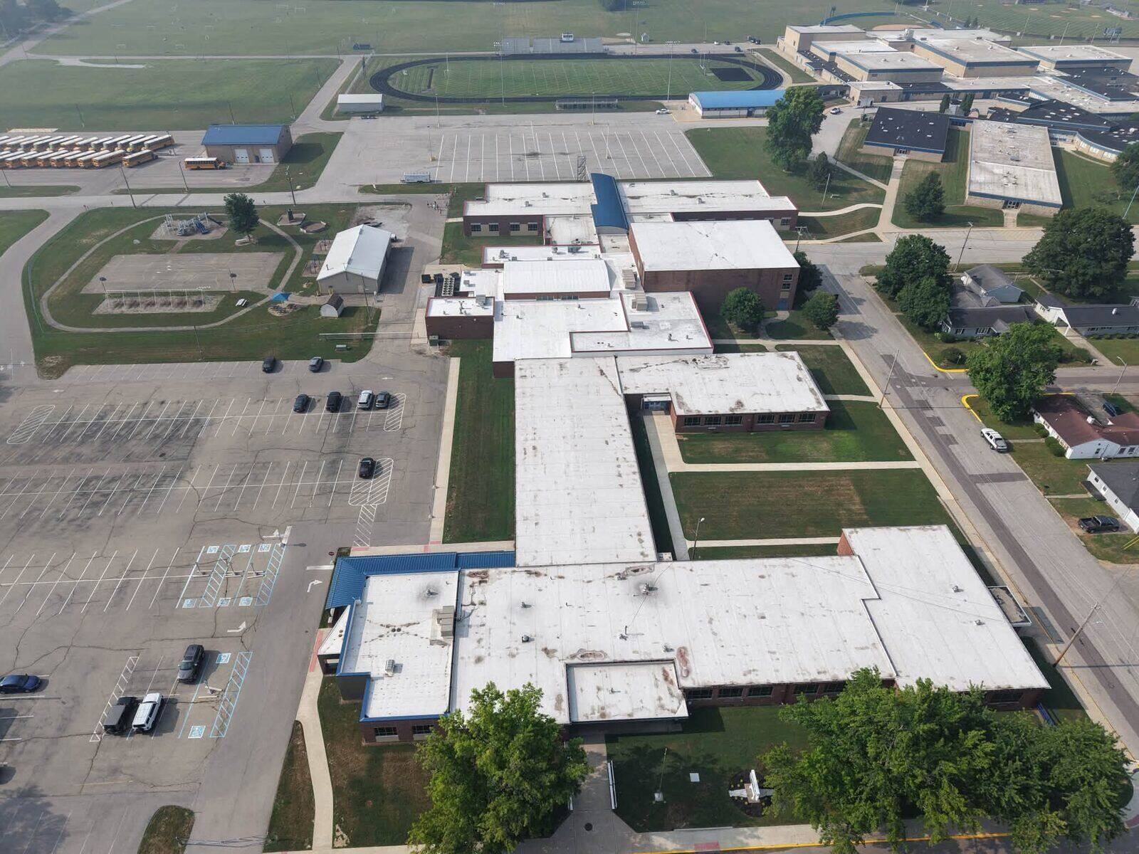 Wide view of low-slope commercial roofing across a multi-building property.