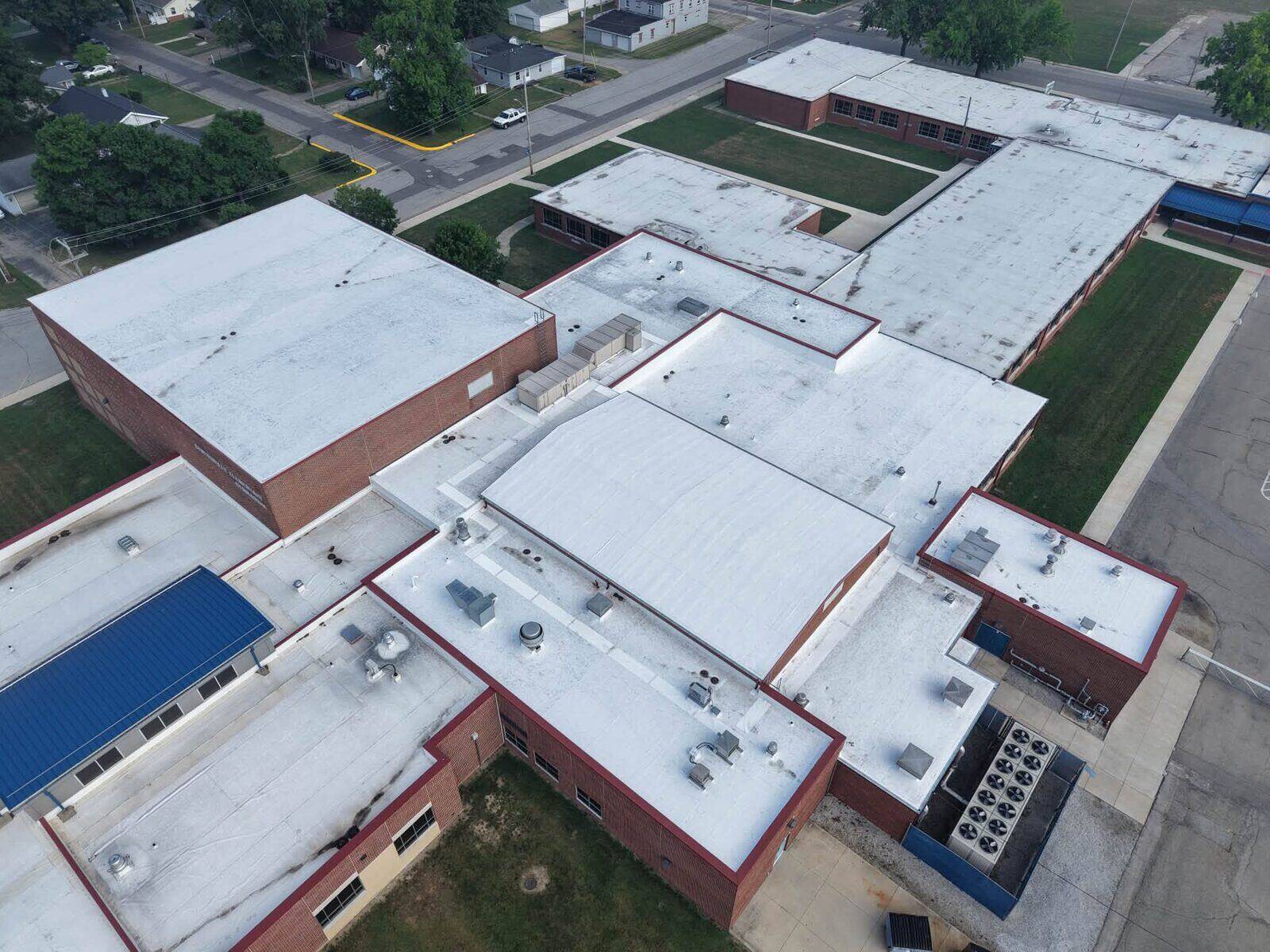 Aerial view of multiple low-slope roofs across a commercial property.
