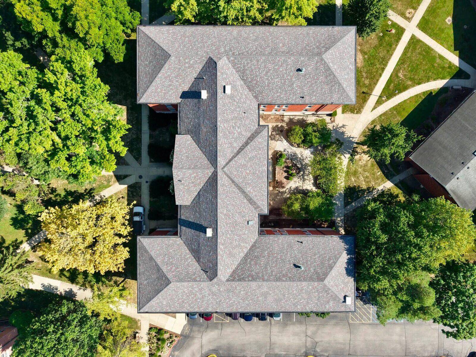 Aerial view of a multi-unit residential building with a completed roof.