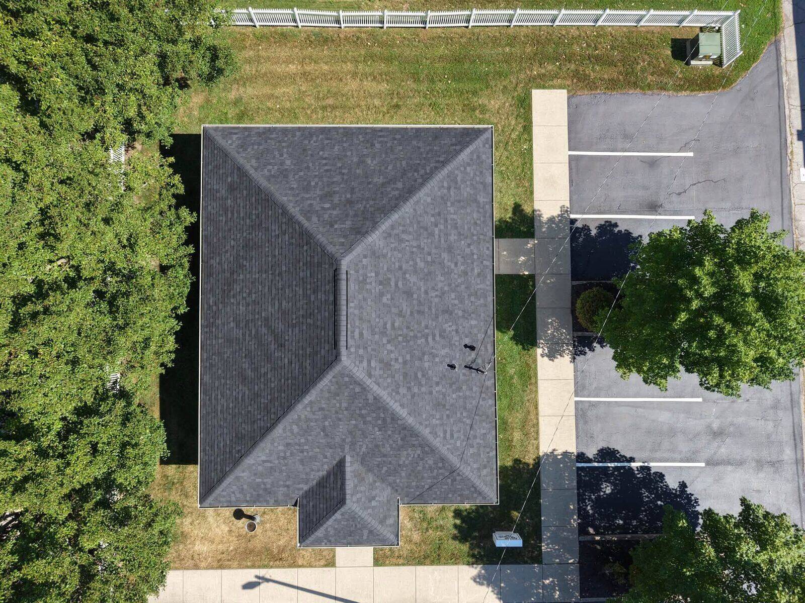 A house with a completed dark architectural shingle roof.